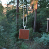Photo of wooden flooring sample silver-plated necklace hanging