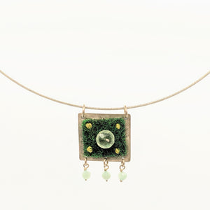 Green carpet and stone bead pendant on steel cable