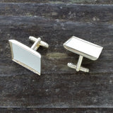 Photo of off-white silver-plated faux-leather upholstery cuff links from above