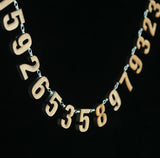 Laser-cut bamboo 21-digit pi necklace
