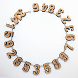 Laser-cut bamboo 21-digit pi necklace
