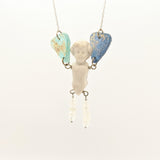 Antique porcelain doll necklace with ancient Roman glass