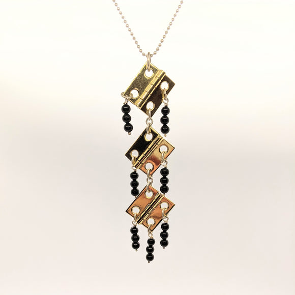 Three-hinge pendant with black onyx beads