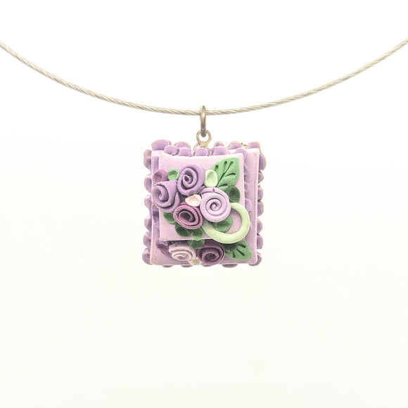 Tiered lavender dollhouse cake pendant necklace on steel cable
