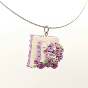 Pink and lavender dollhouse cake pendant necklace on steel cable