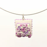Pink and lavender dollhouse cake pendant necklace on steel cable