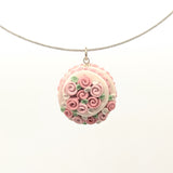 Pink dollhouse cake pendant necklace on steel cable