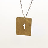 Vintage brass number and letter stencil necklace