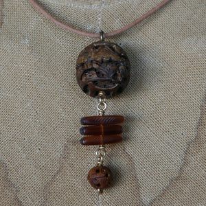 Horn and seed pendant on leather cord