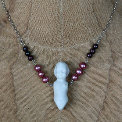 Antique porcelain doll necklace with garnet pearls
