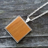 Photo of wooden flooring sample silver-plated necklace from above