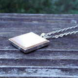 Photo of wooden flooring sample silver-plated necklace, side view