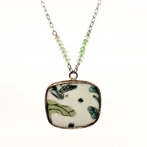 Lilypad pottery necklace with green faceted stone beads