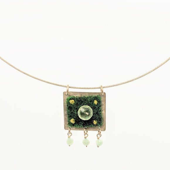 Green carpet and stone bead pendant on steel cable
