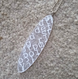 Large recycled plastic pendant with white type - Amy Jewelry

