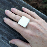 Photo of silver-plated upholstery ring on hand